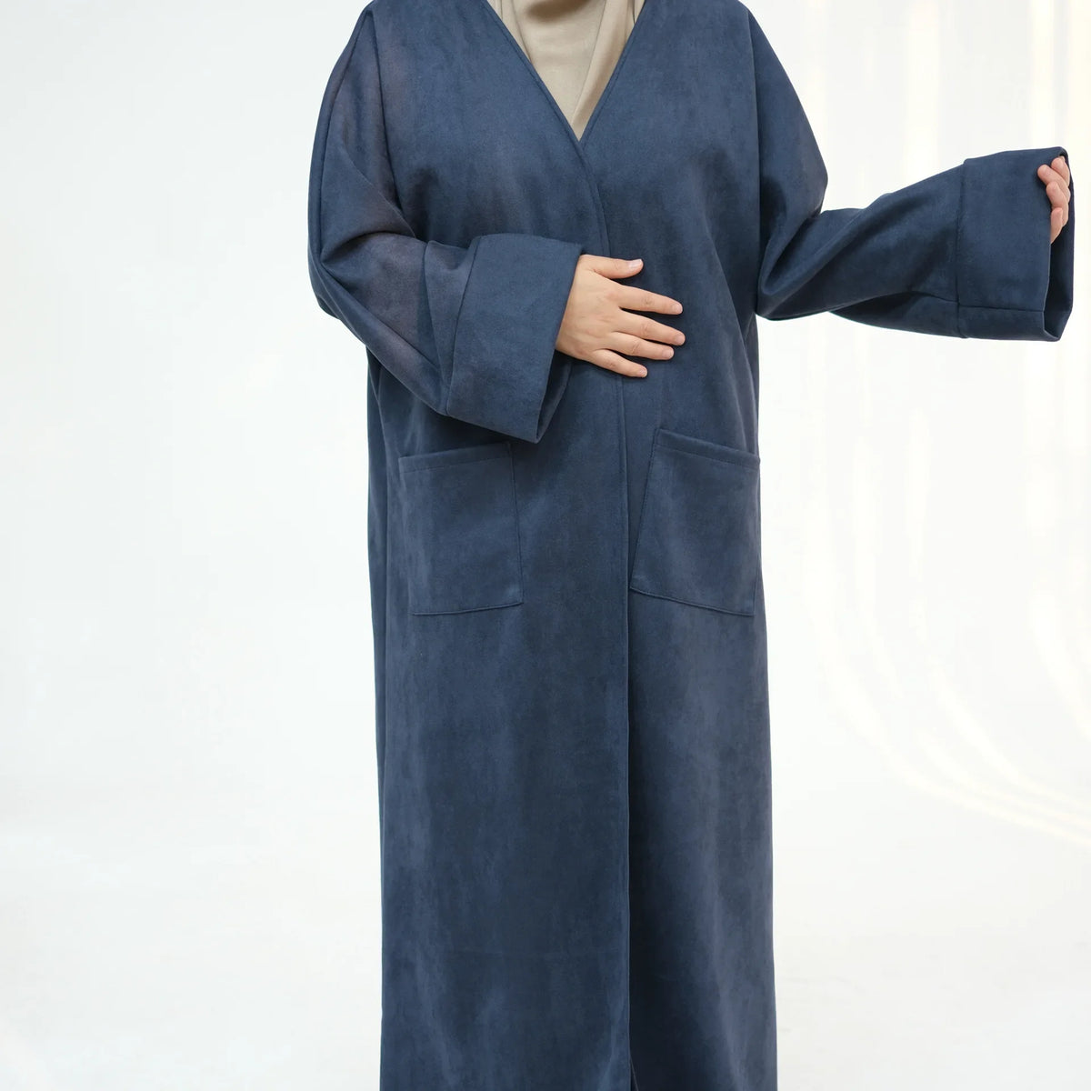 A dark blue elegant women's abaya trench coat worn by a model.