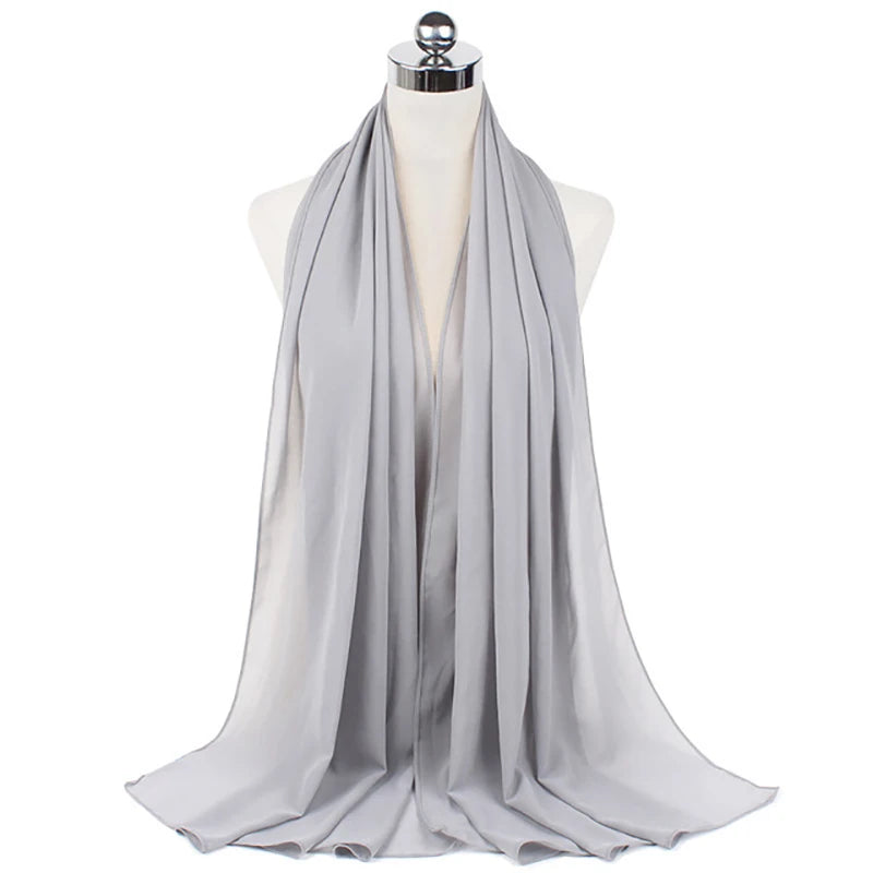 A light gray chiffon hijab scarf draped around a mannequin's neck.