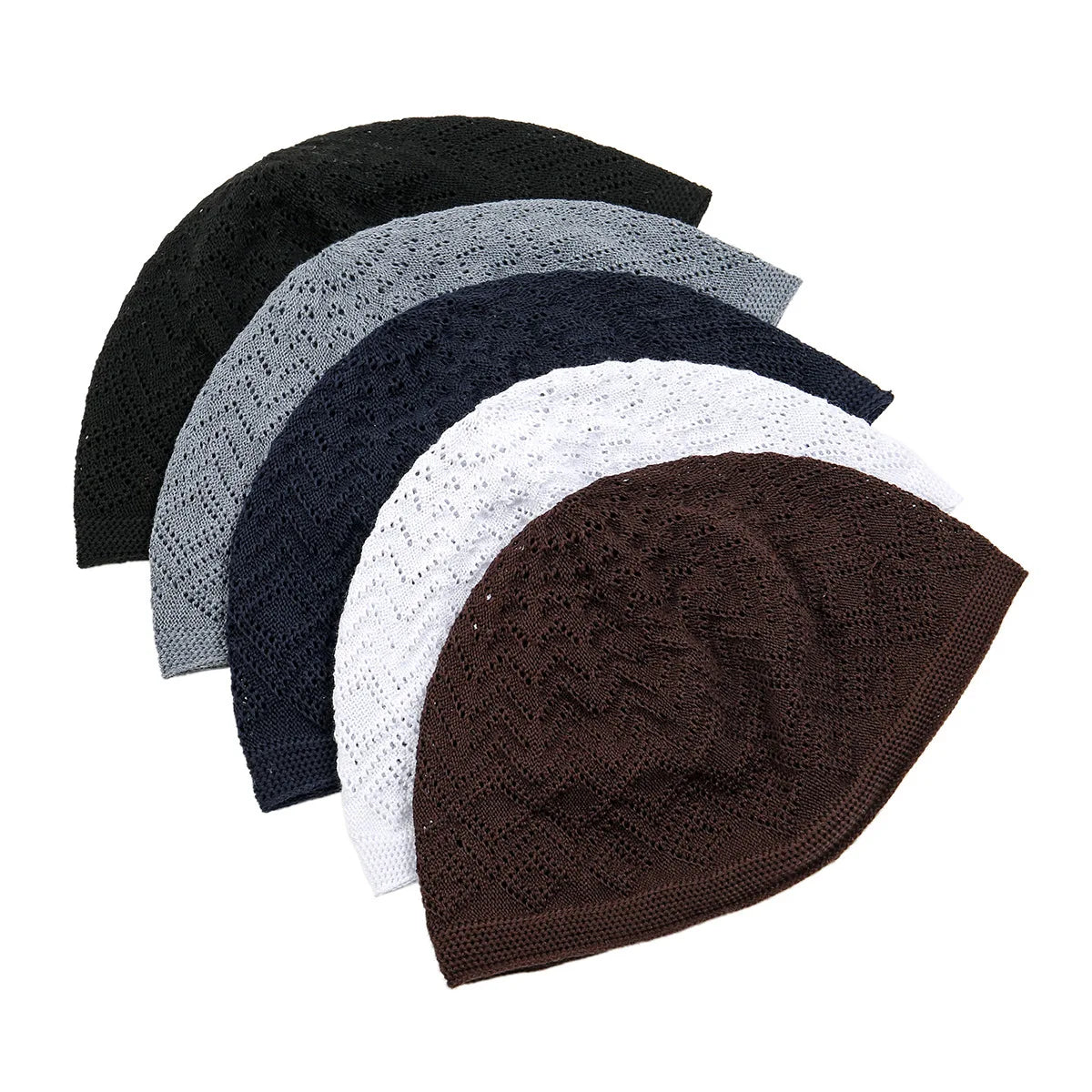 A stack of five knitted prayer hats or kufis in various shades including black, gray, navy blue, and brown.
