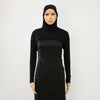Model in a black long-sleeved turtleneck dress and matching black hijab.