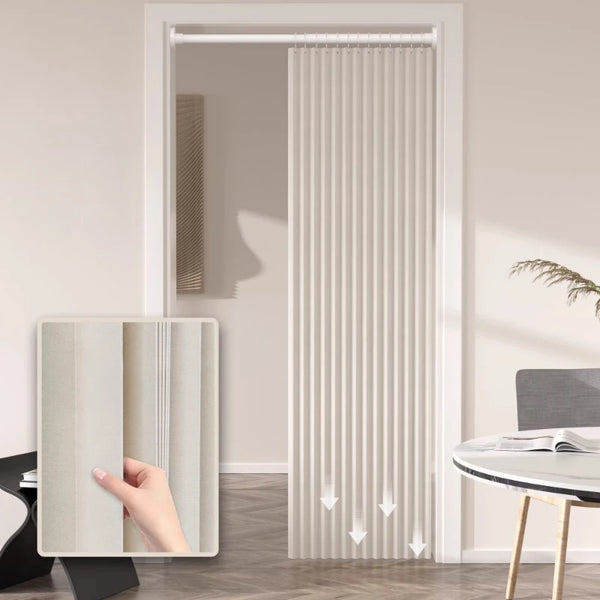 A close-up view of a pleated accordion door curtain in a light beige color installed in a white door frame.
