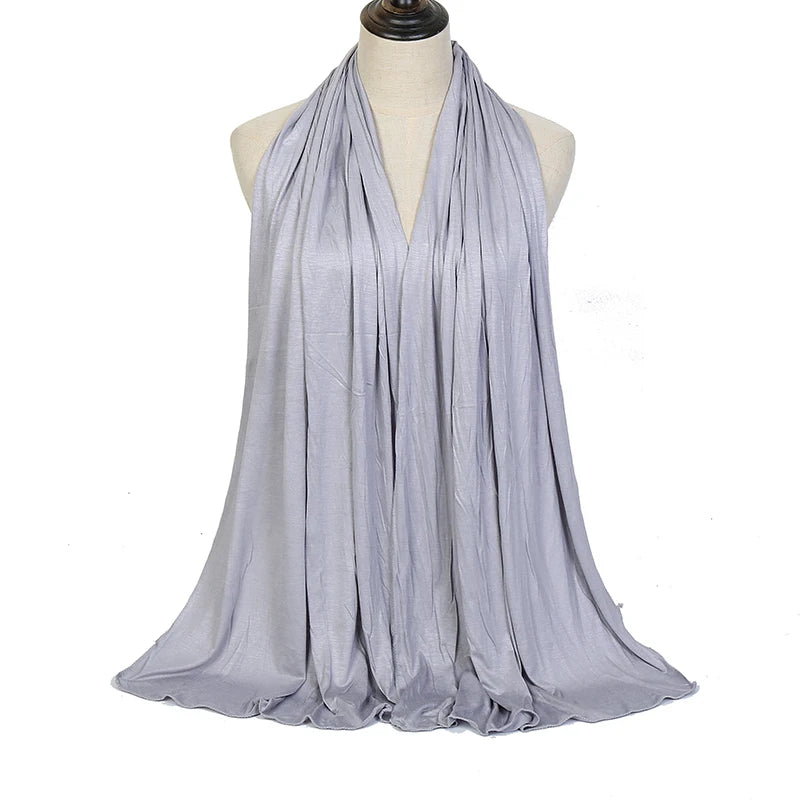 A light gray soft modal jersey hijab scarf draped around a mannequin's neck.