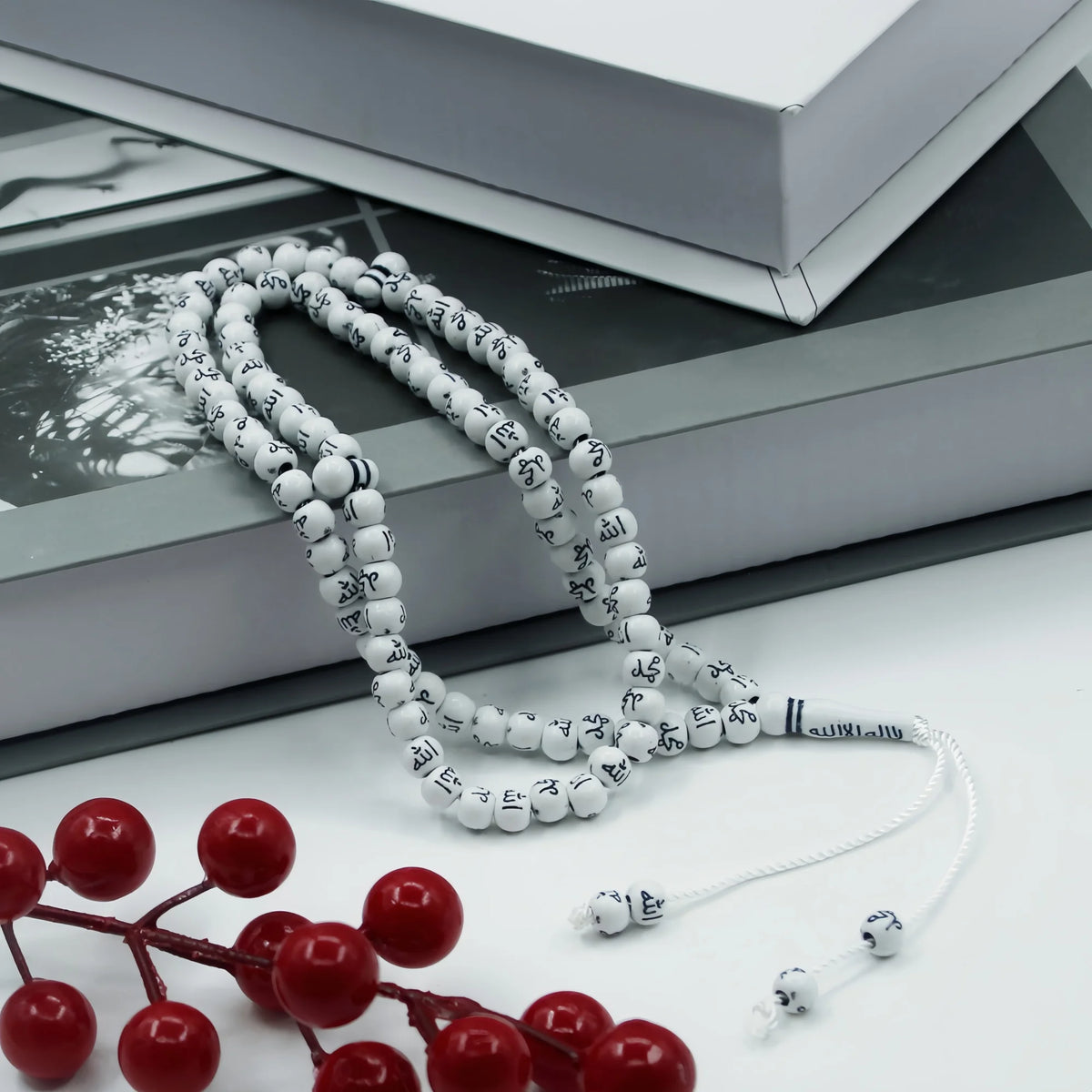 White 99 bead Islamic prayer tasbih for meditation and prayer with a red branch