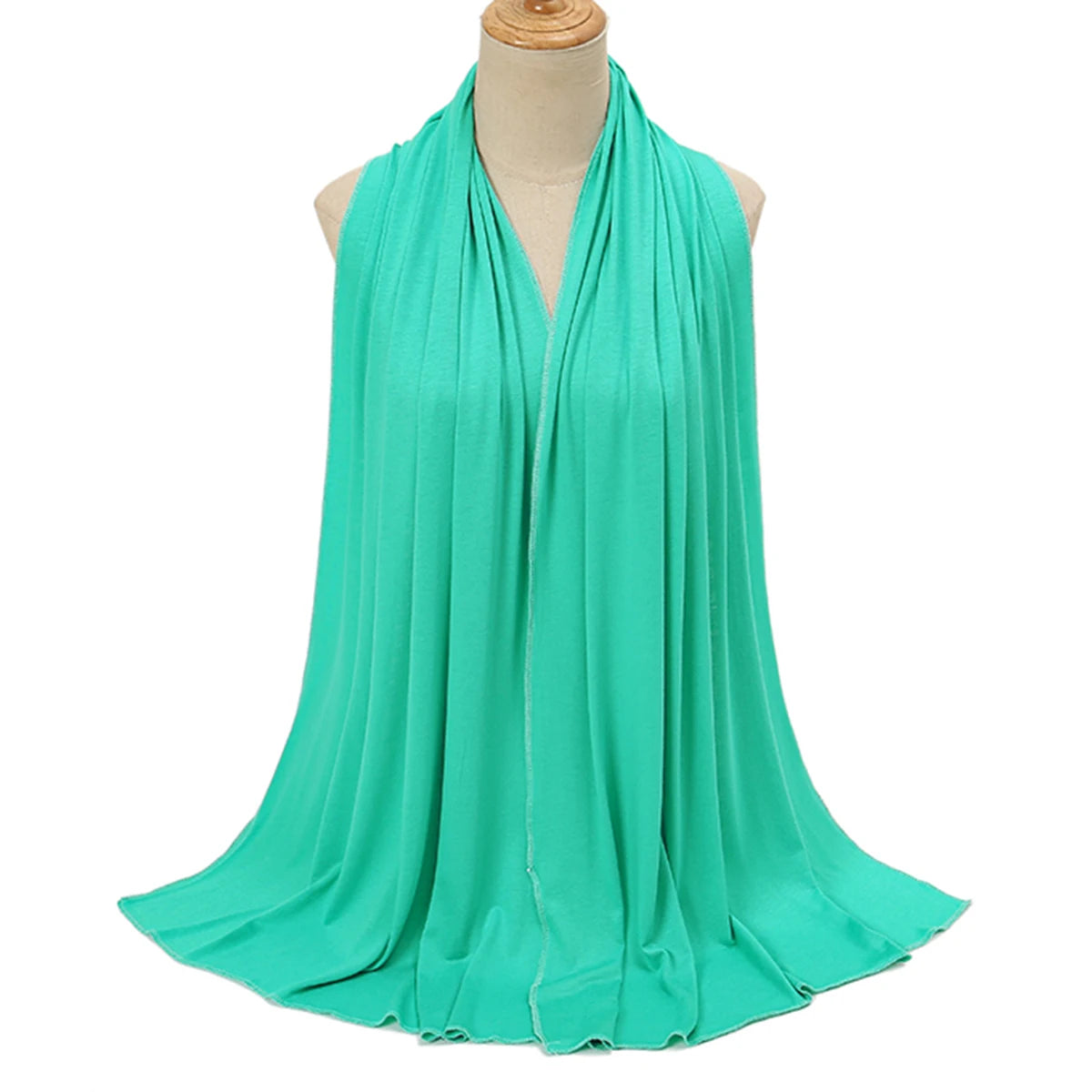 A teal soft modal jersey hijab scarf draped around a mannequin's neck.