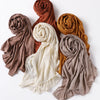 A collection of five ribbed jersey hijab scarves in shades of terracotta, beige, and cream.