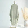 A sheer sage green ruffled two-layer chiffon hijab displayed on a wooden hanger.