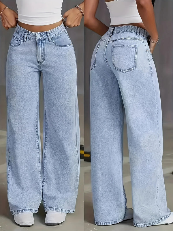 A woman models light blue wide leg denim pants with a white cropped top.