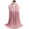 A flowing dusty rose modal jersey hijab draped around a mannequin's neck.