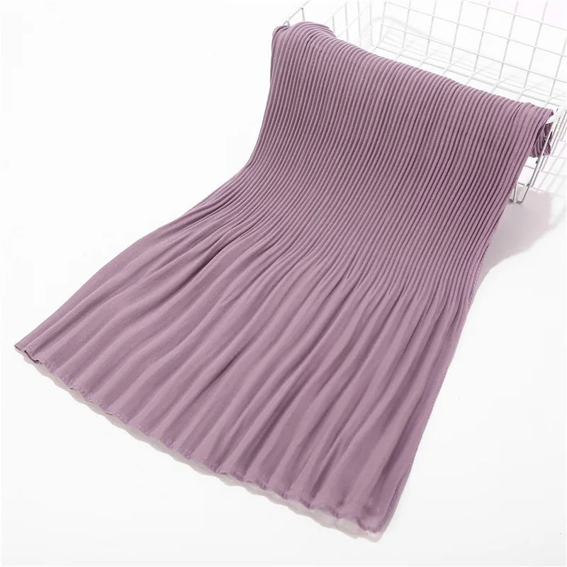 Mauve crinkle chiffon hijab scarf draped and folded on a white surface.
