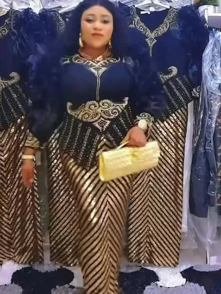 A woman models a gold and black sequin African party dress with dark fur accents.