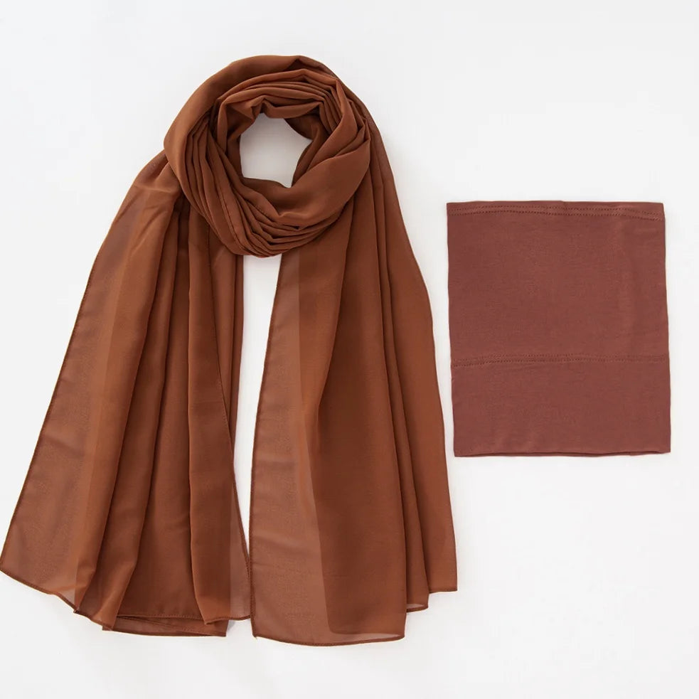 A flowing, rust-colored chiffon hijab and matching undercap set displayed flat.