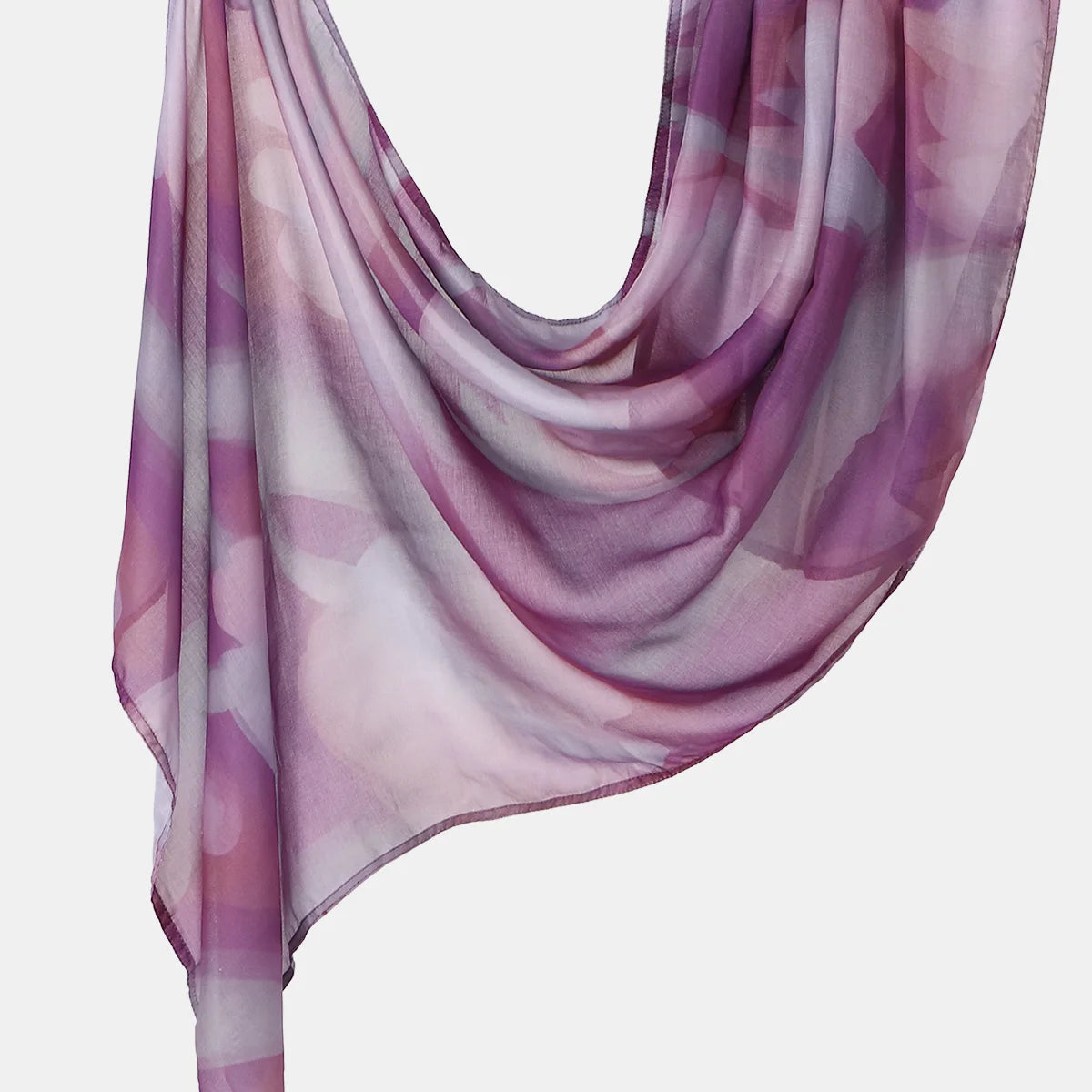 A flowing, sheer lilac and purple printed linen hijab scarf draped elegantly.