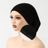 A woman wearing a black elegant anti-slip inner hijab cap on her head.