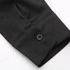Man's black Muslim robe sleeve showing a button closure and retro embroidery detail.