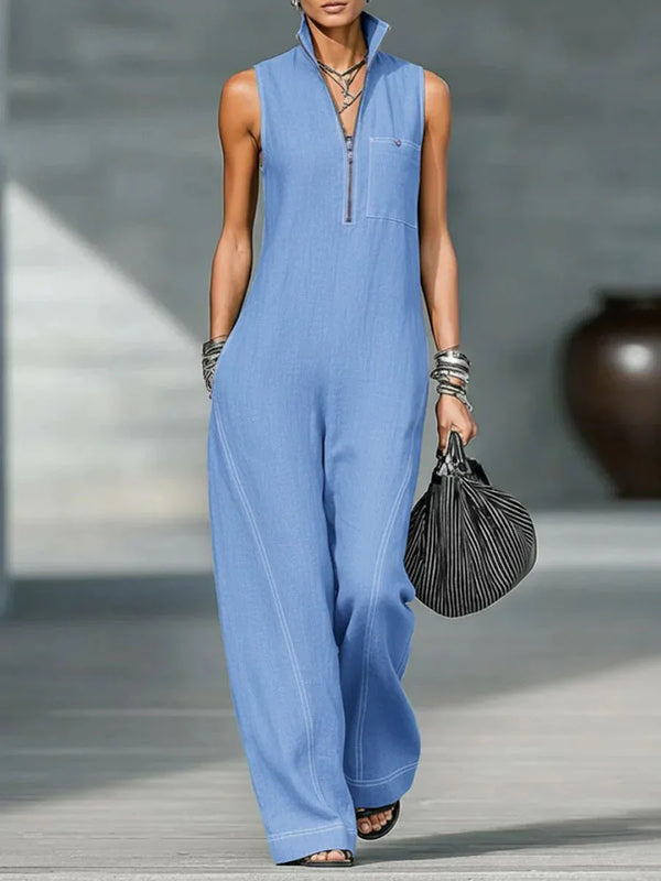 A woman models a light blue relaxed knit sleeveless top with a collar and long sleeves, paired with matching trousers.