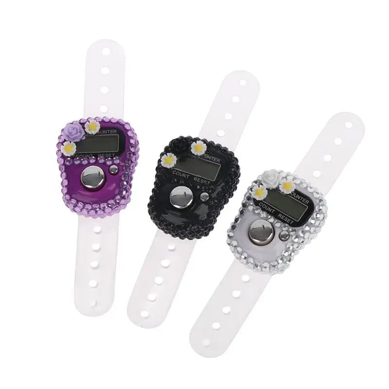 A colorful finger counter with a purple silicone body and a clear strap, designed for meditation and counting.