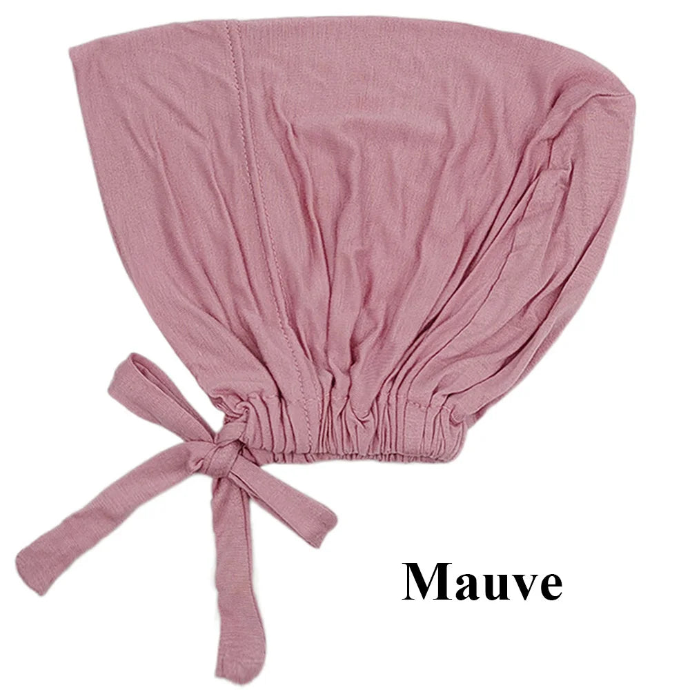 Pañuelo turbante modal color malva suave doblado y atado en la parte inferior.