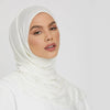 A woman wearing a white stretchy jersey plain hijab scarf.