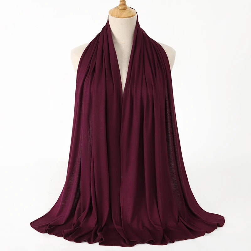 A deep burgundy premium modal jersey hijab draped around a mannequin's neck.