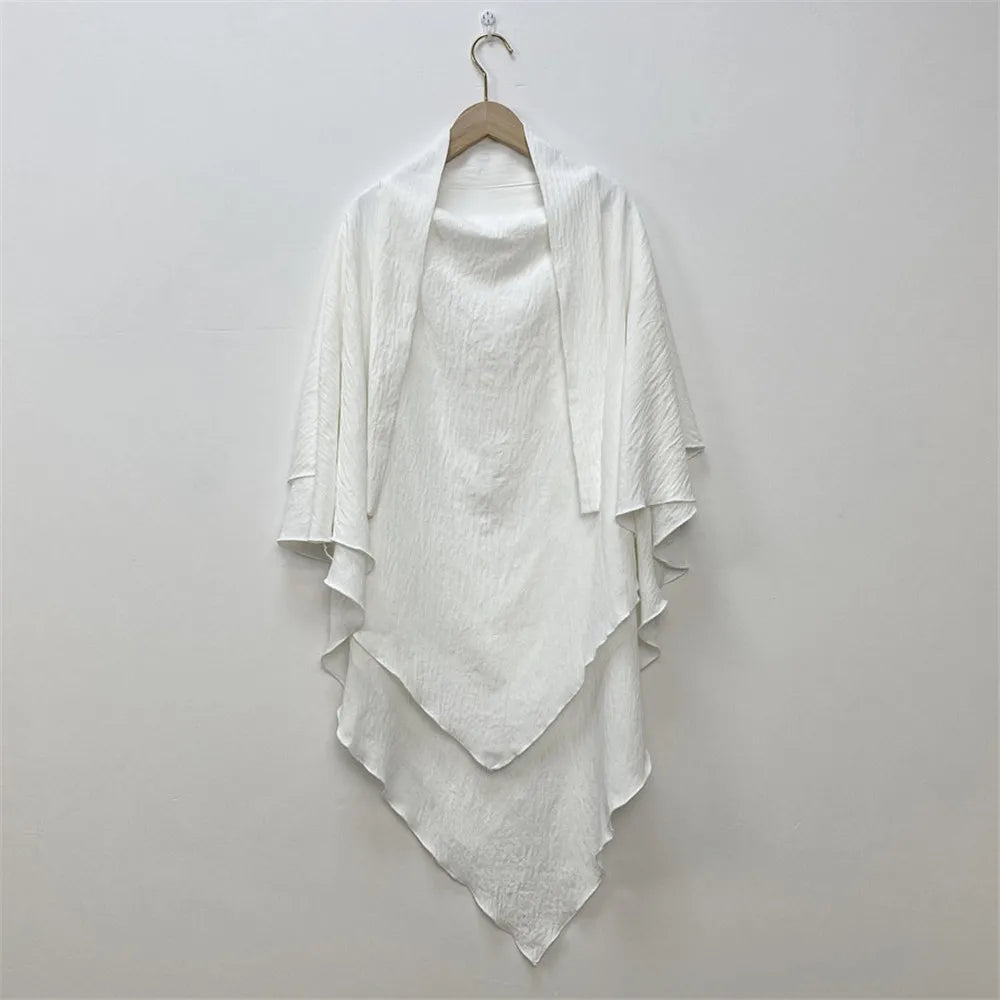 White two-layer everyday hijab scarf draped on a hanger against a light wall.