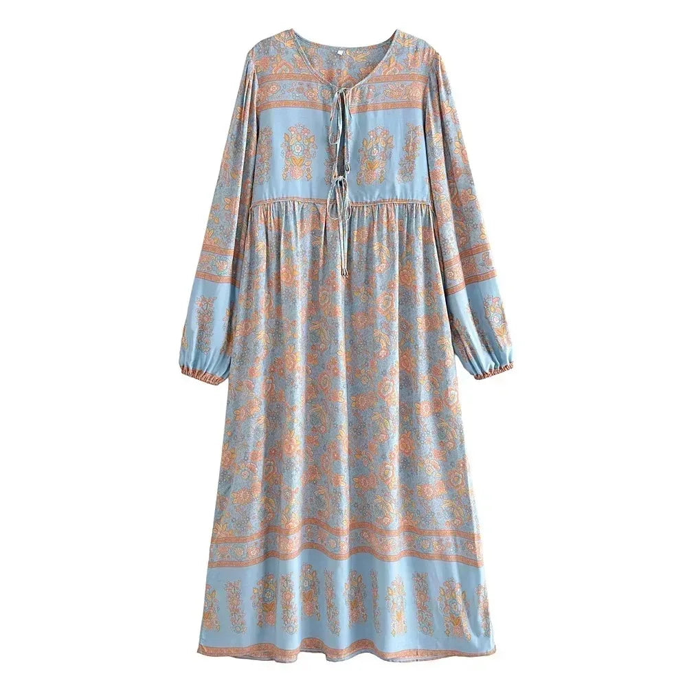 A long-sleeved bohemian floral maxi dress in light blue with orange and pink patterns.
