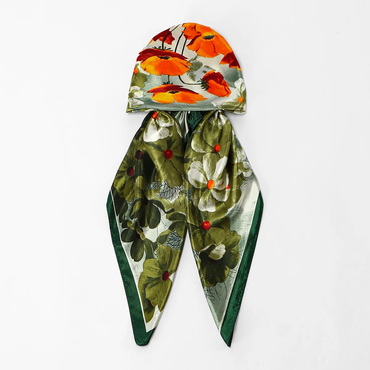 An elegant satin silk instant hijab scarf featuring a floral print with orange and yellow flowers on a green background.
