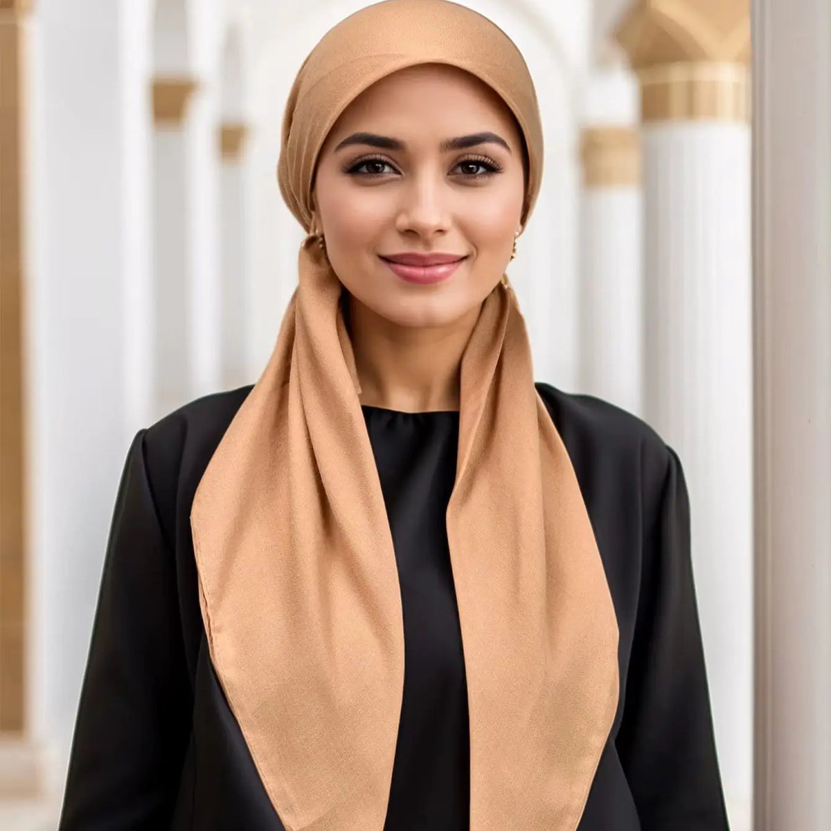 A woman wearing a solid linen elastic headscarf cap and black clothing.