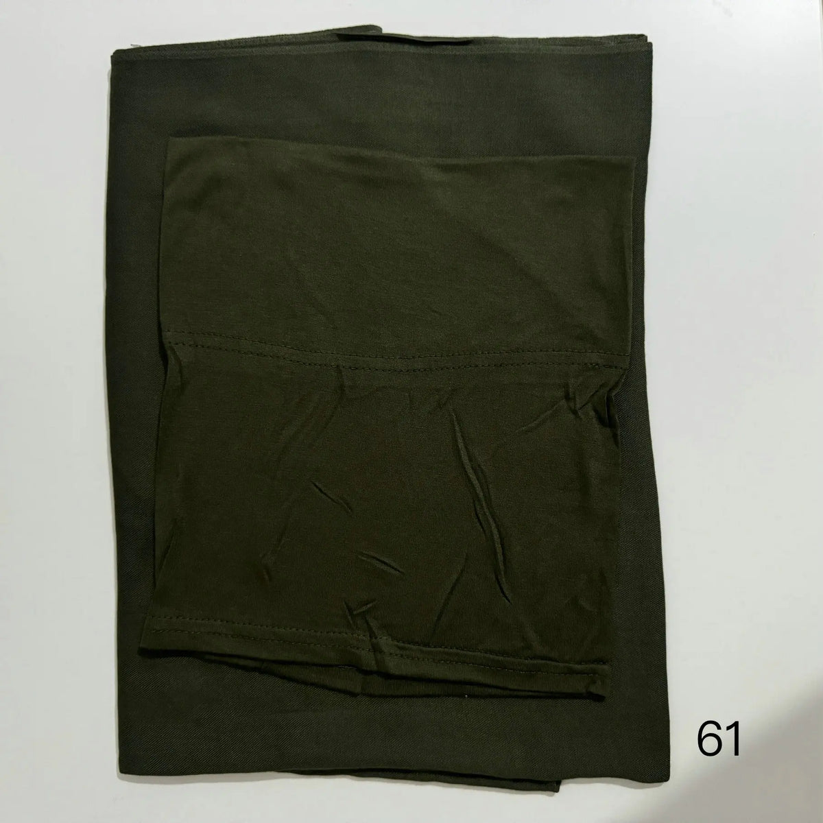 A dark olive green soft modal rayon hijab set folded flat.