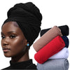 Model wearing a black stretchy jersey turban head wrap and several rolled fabric wraps.