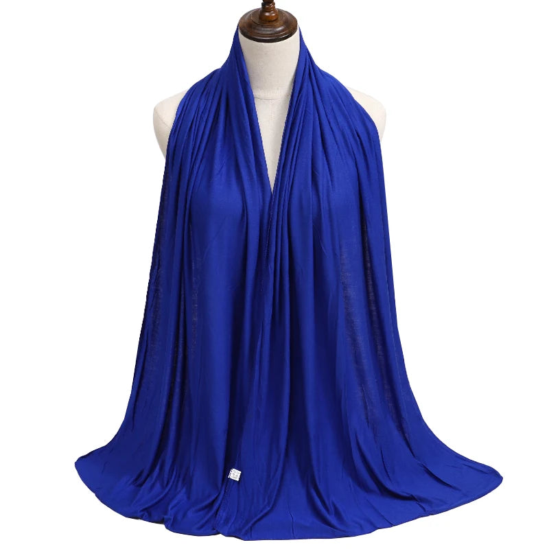 A vibrant royal blue premium modal jersey hijab draped around a mannequin's neck.