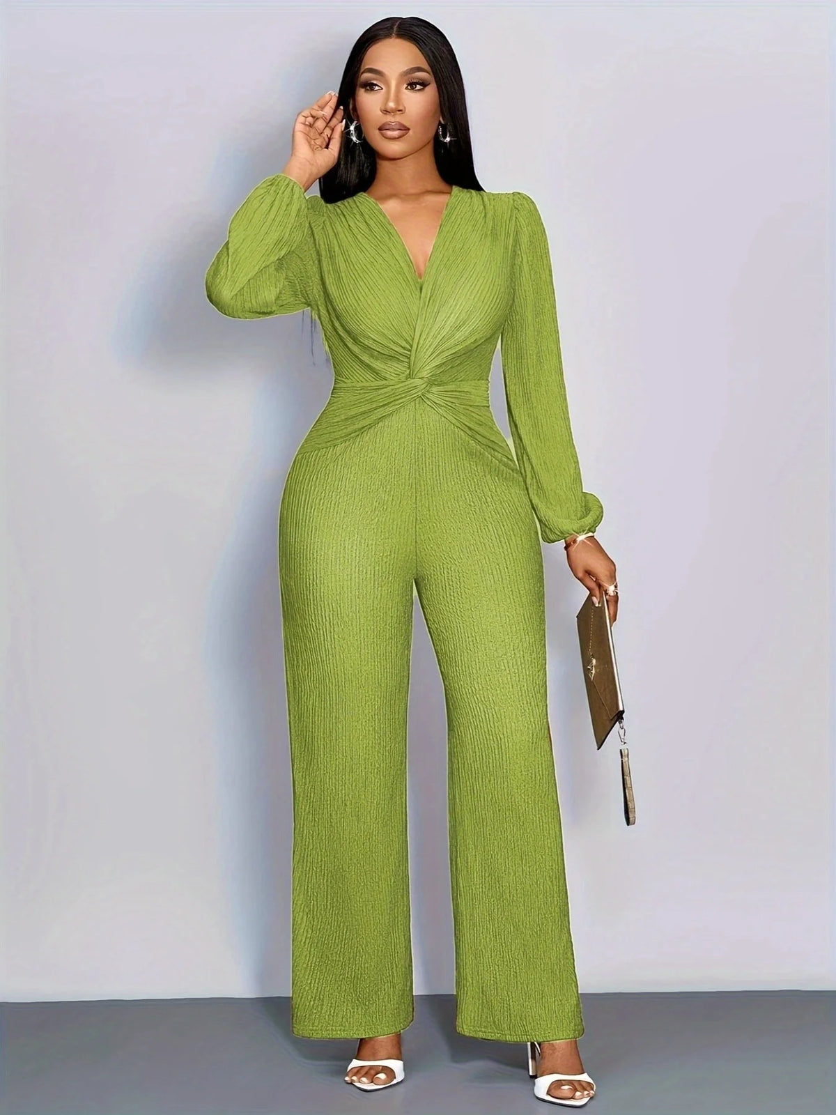 A woman models a lime green ribbed knit jumpsuit with puff sleeves against a light gray background.
