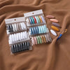 A collection of 40 solid color brooch pins in various shades of pink, blue, green, and beige packaged in clear plastic.