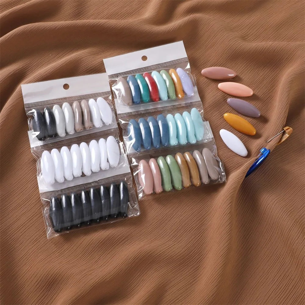 A collection of 40 solid color brooch pins in various shades of pink, blue, green, and beige packaged in clear plastic.