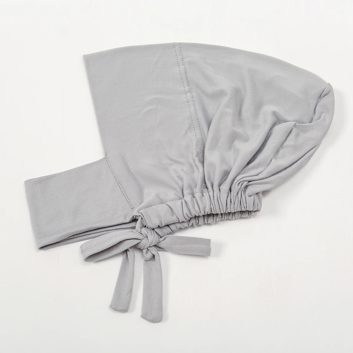 A light gray inner hijab cap scarf made of cotton polyester with a gathered knot detail.