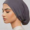 Model wearing a solid gray bamboo jersey tube hijab cap