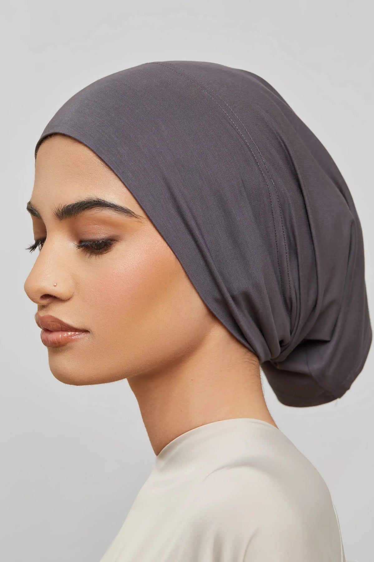 Model wearing a solid gray bamboo jersey tube hijab cap