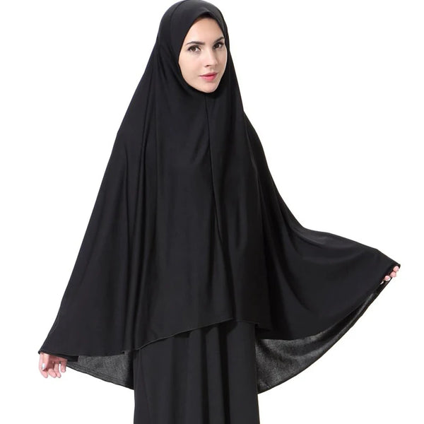 A woman wearing an elegant black lightweight hijab scarf for modest wear.