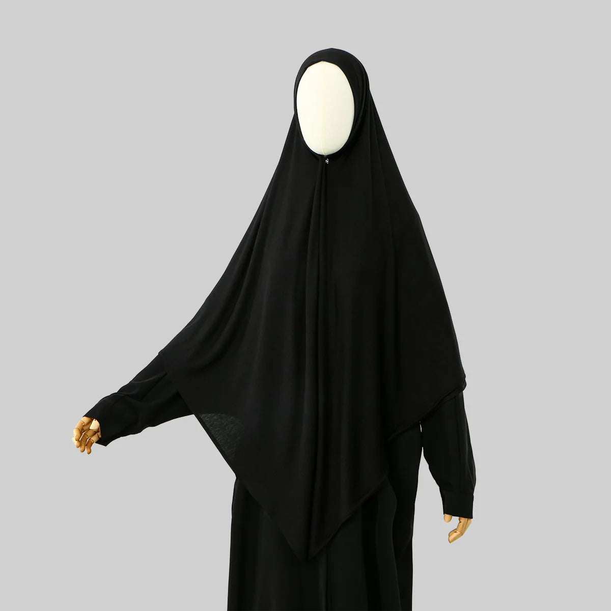 A black large size stretchy modal square scarf for Islamic wear displayed on a mannequin.