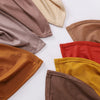 Una colección de cinco pañuelos de jersey doblados en varios tonos tierra, incluyendo marrón, beige, naranja y rojo.