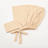 A beige cotton polyester inner hijab cap scarf tied at the bottom, shown flat.