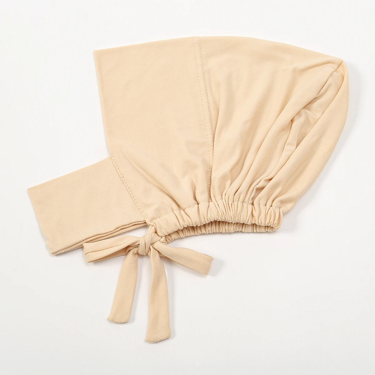 A beige cotton polyester inner hijab cap scarf tied at the bottom, shown flat.