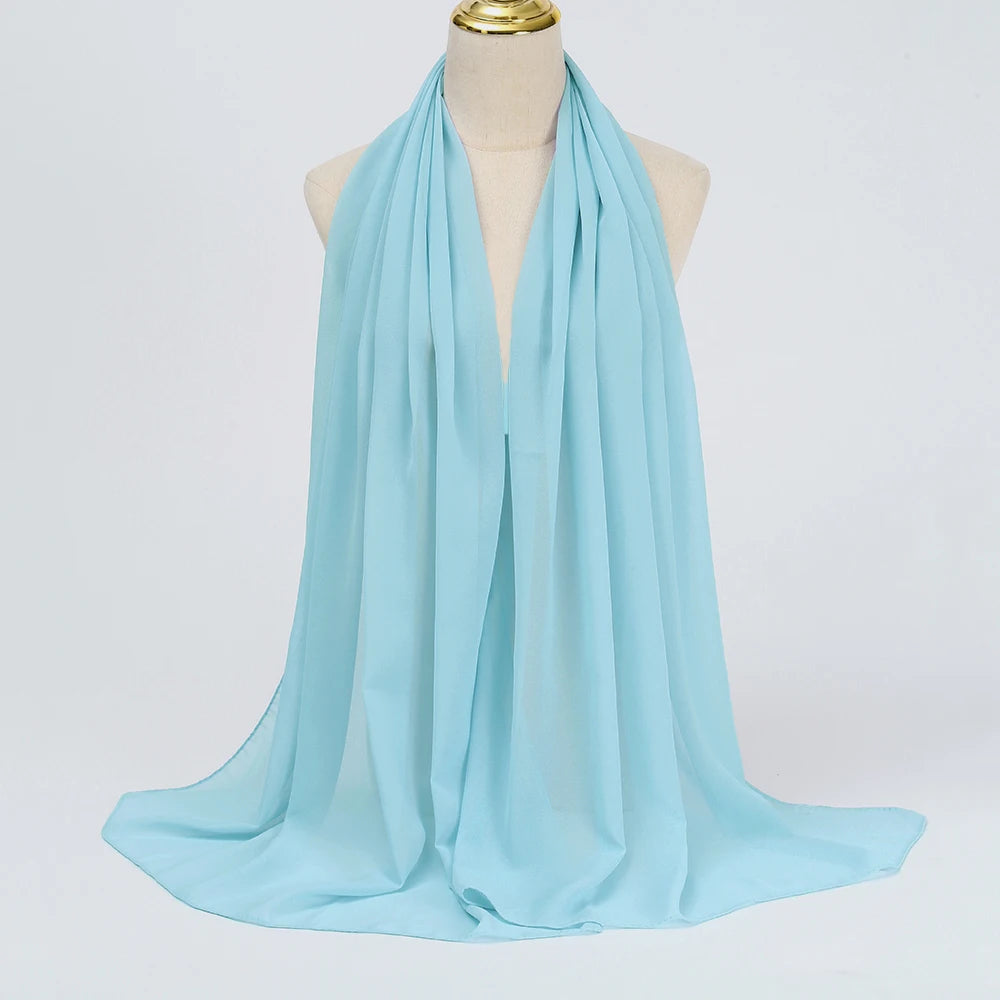Ein hellblaues Chiffon-Hijab-Tuch, drapiert um den Hals einer Mannequin.