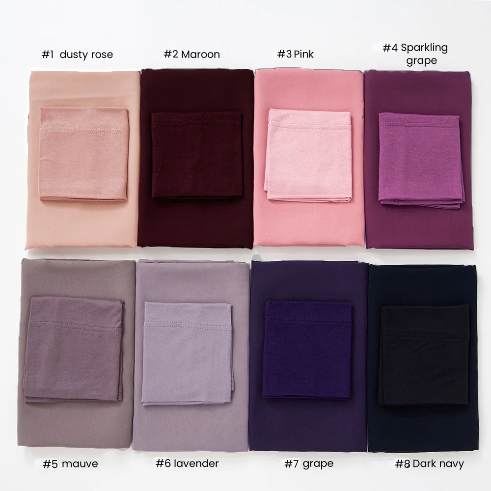 A collection of eight colored chiffon hijab and undercap sets displayed in a row.