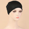 A black classic stretch jersey turban cap displayed on a mannequin head.
