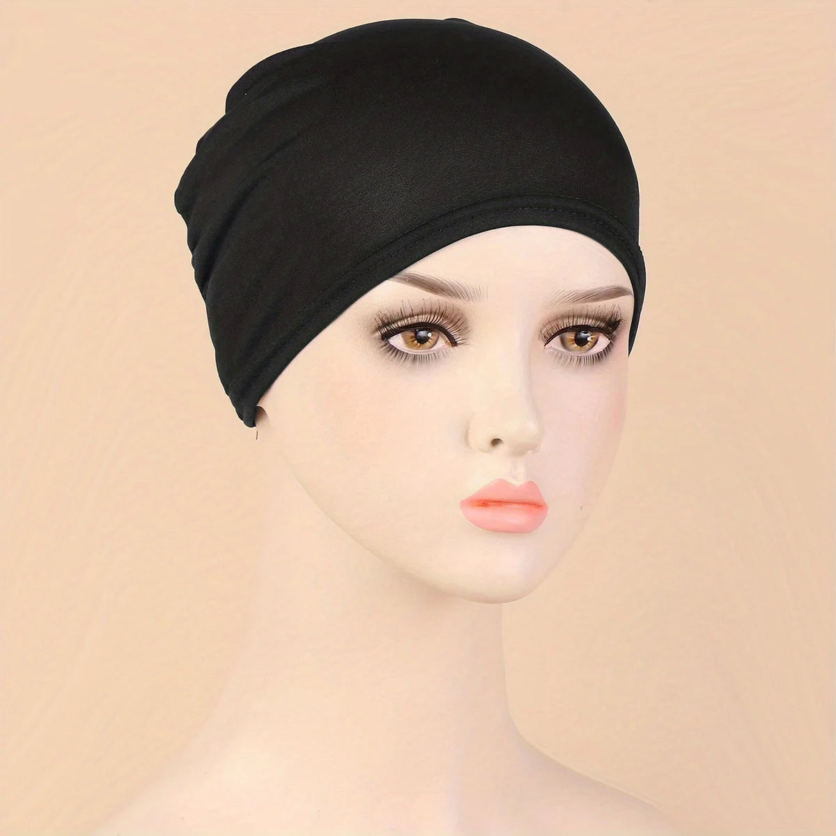 A black classic stretch jersey turban cap displayed on a mannequin head.