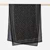 Black printed linen hijab scarf draped over a wooden rod.