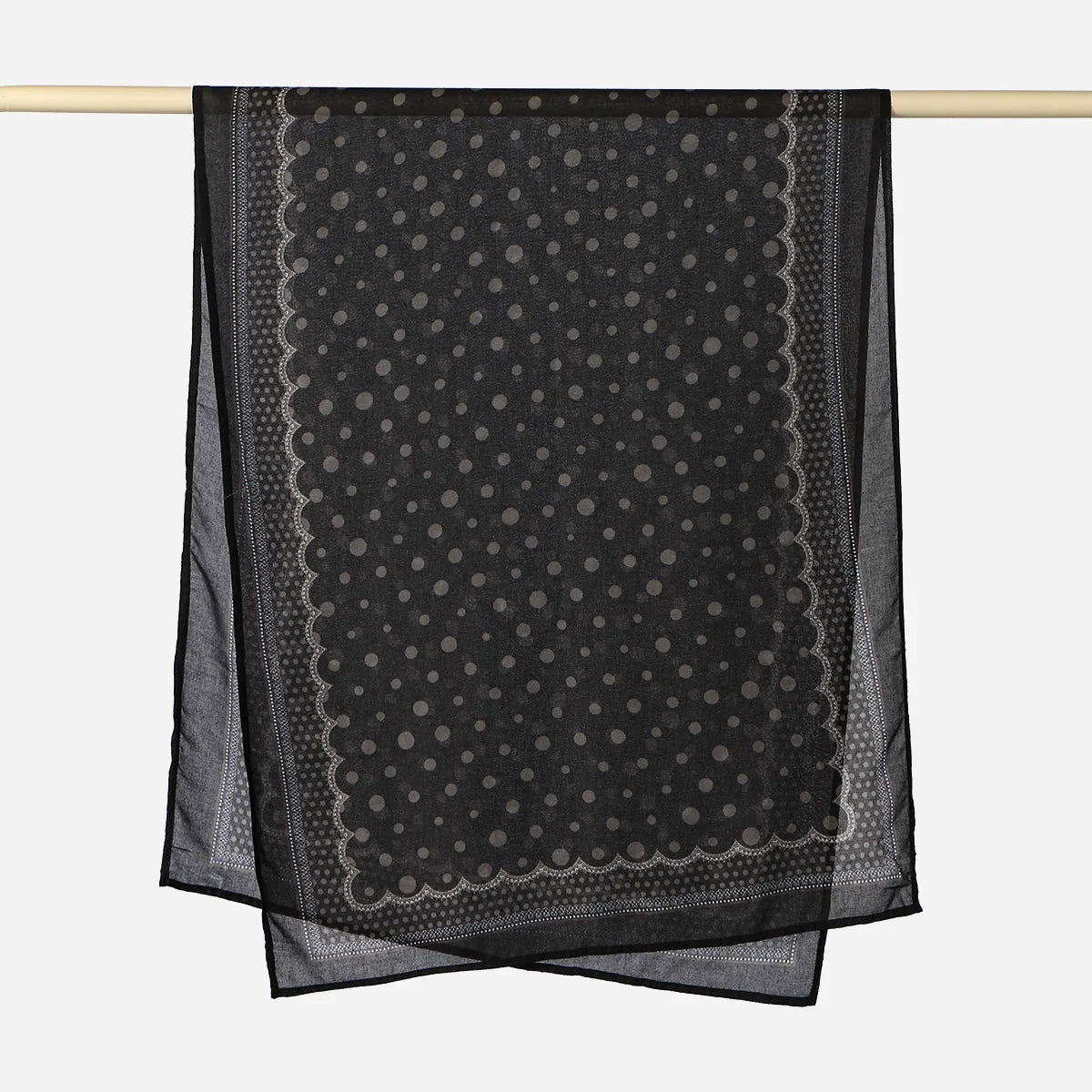 Black printed linen hijab scarf draped over a wooden rod.