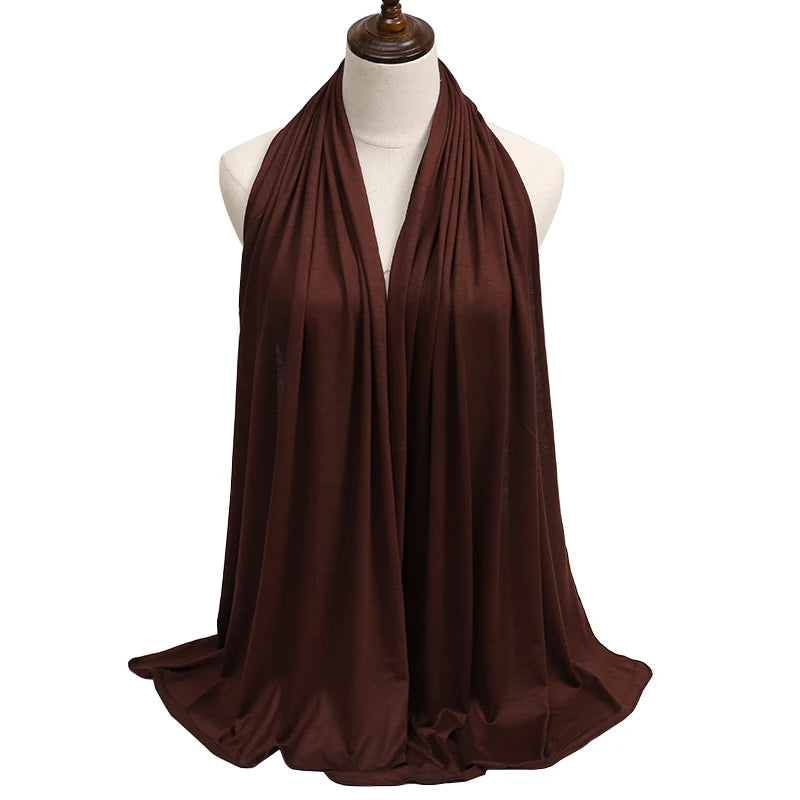 A dark brown premium modal jersey hijab draped around a mannequin's neck.
