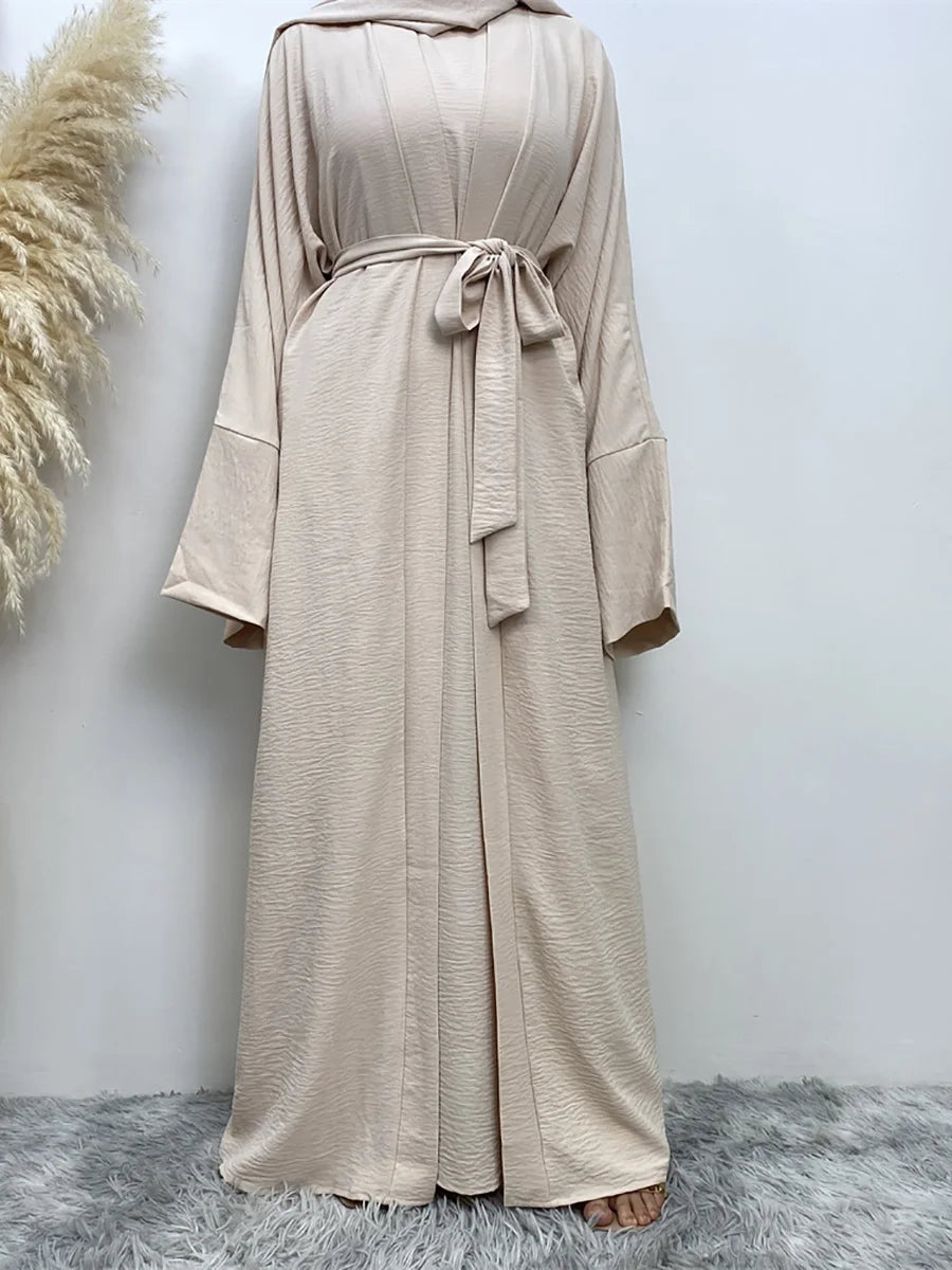 A beige elegant women's abaya and kaftan set featuring a flowing, long-sleeved garment tied at the waist.
