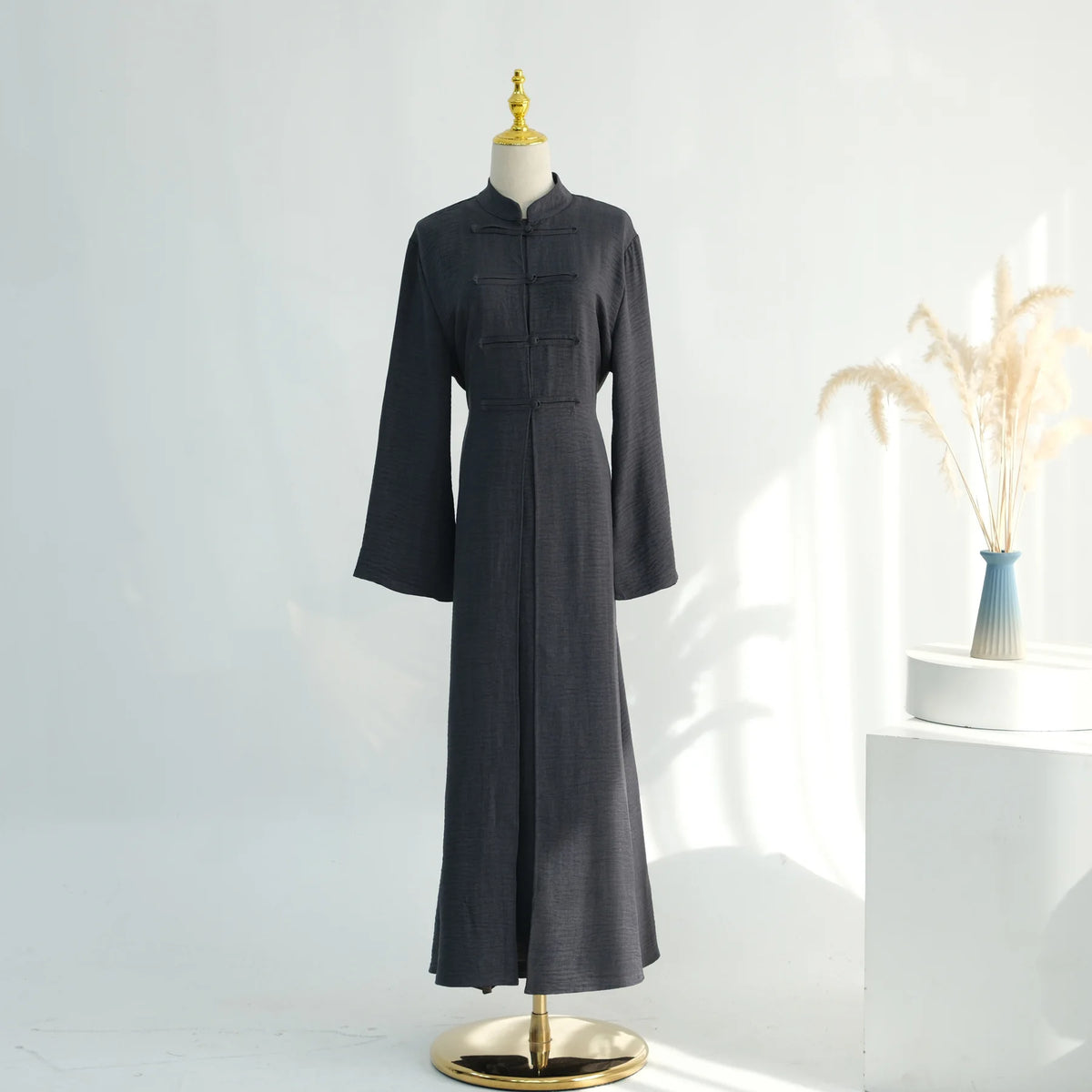 A dark charcoal gray elegant two-piece Arabic modest set displayed on a mannequin.